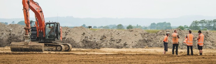 Four men consulting about earthworks in the Bay of Plenty region.